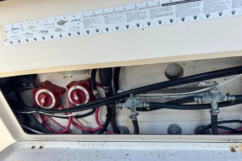 Slide: The Image of Electrical and plumbing components inside a 2003 KenCraft 235 Challenger boat. - 52