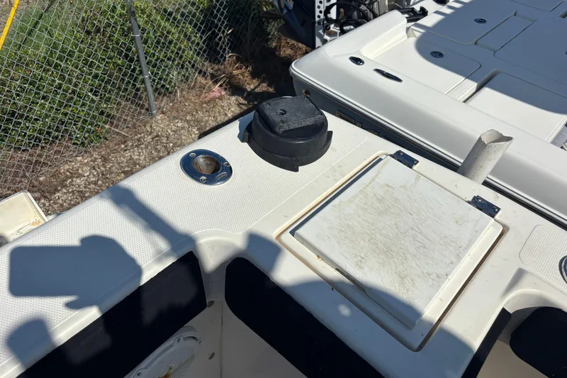 Slide: The Image of 2003 KenCraft 235 Challenger boat deck with storage compartments and rod holder. - 53