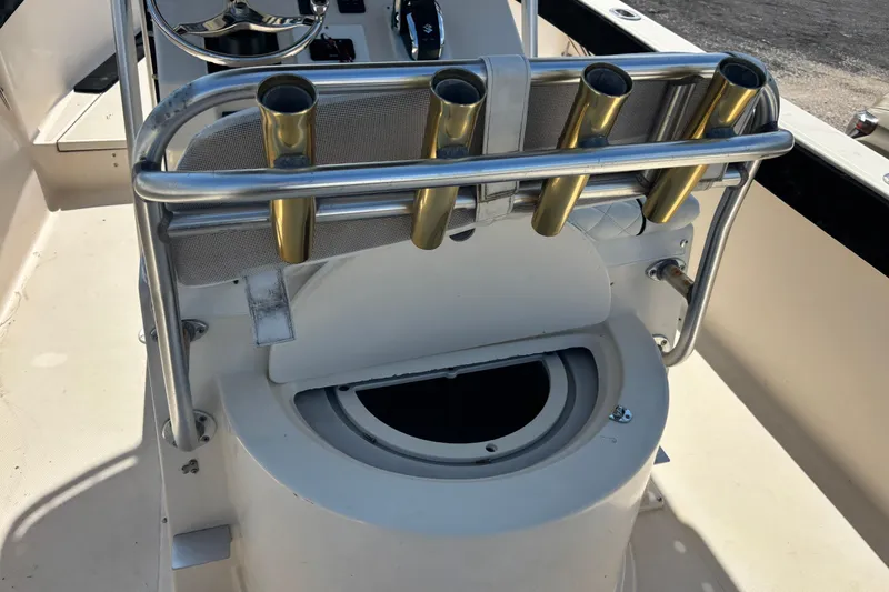 Slide: The Image of 2003 KenCraft 235 Challenger boat console with rod holders and steering wheel. - 57