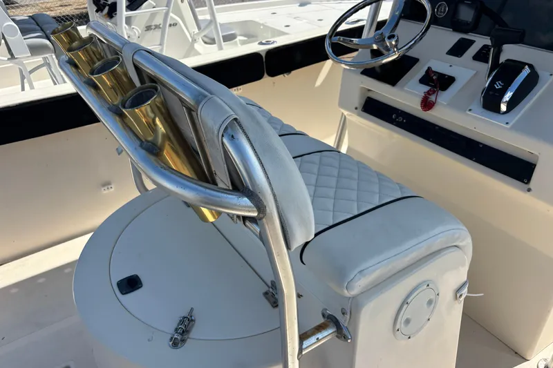 Slide: The Image of 2003 KenCraft 235 Challenger boat interior with steering wheel and rod holders. - 62