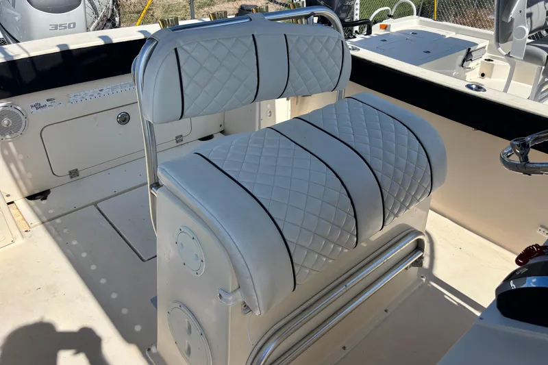 Slide: The Image of 2003 KenCraft 235 Challenger boat interior with quilted white seating and steering area. - 63