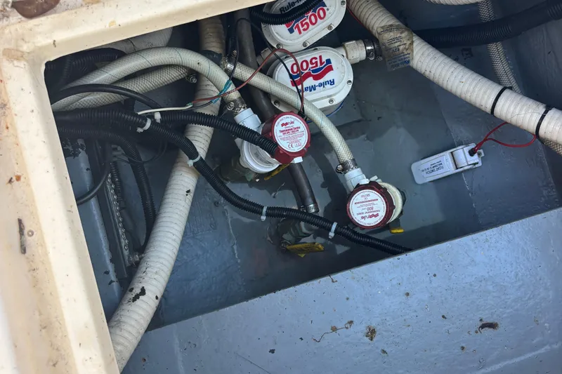 Slide: The Image of Bilge area of 2003 KenCraft 235 Challenger with pumps and wiring visible. - 64