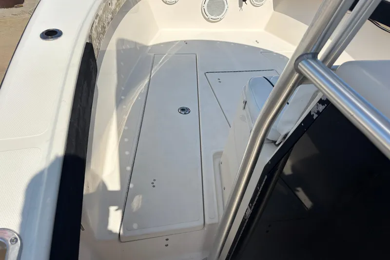 Slide: The Image of 2003 KenCraft 235 Challenger boat interior with seating and storage compartments. - 68