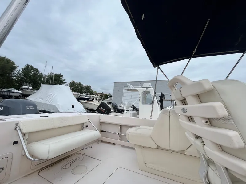 Slide: The Image of 2006 Grady-White Tournament 225 boat interior with seating and canopy, docked at marina. - 5