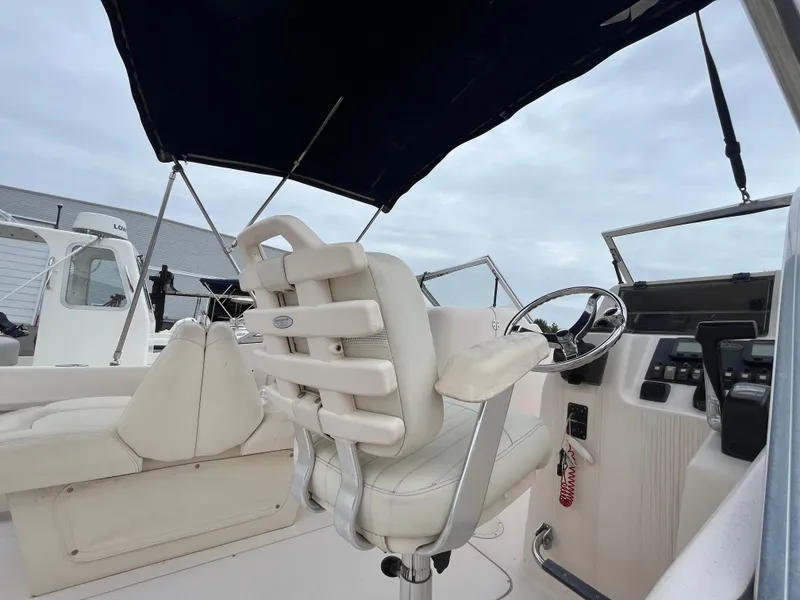 Slide: The Image of 2006 Grady-White Tournament 225 boat interior with steering wheel and seating. - 6