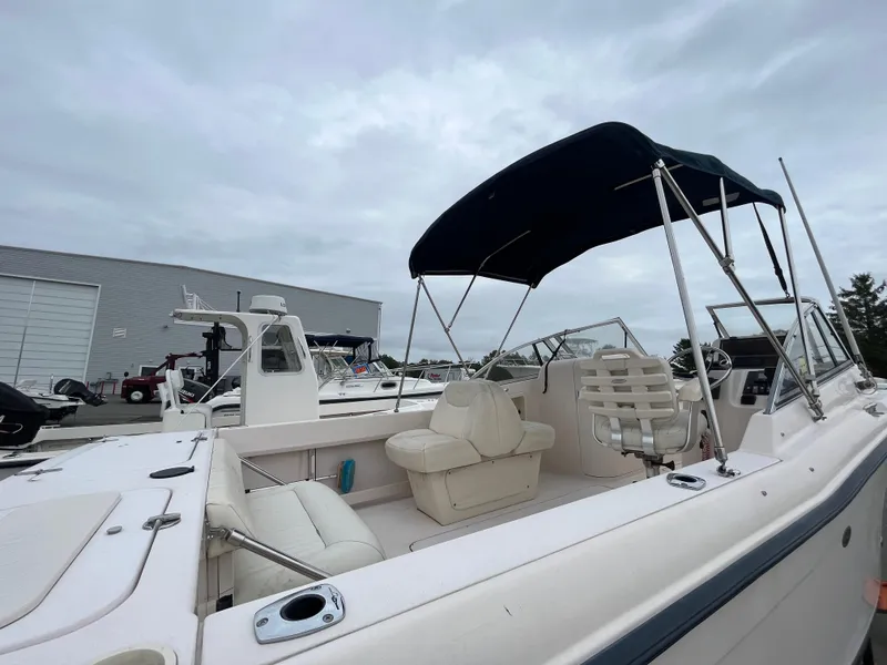 Slide: The Image of 2006 Grady-White Tournament 225 boat with canopy, docked at marina. - 7