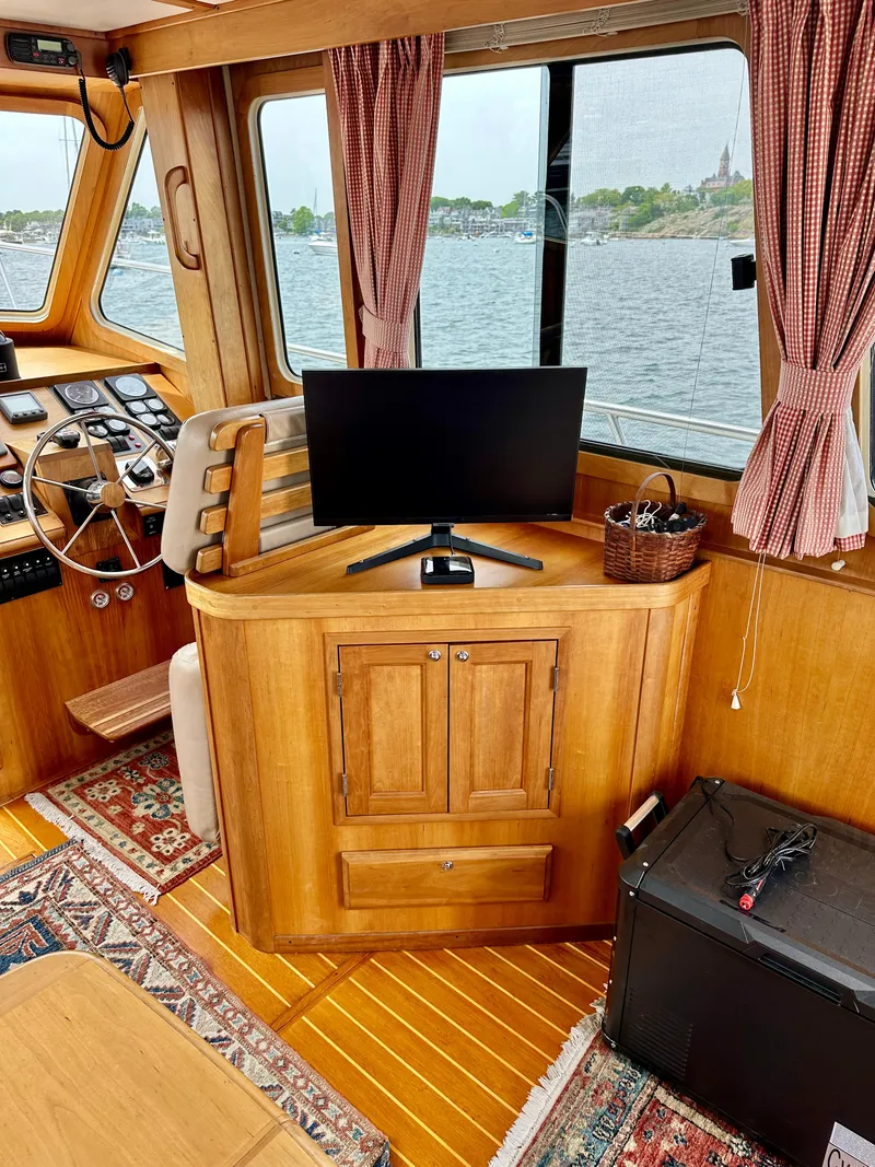 Slide: The Image of Interior of 2002 Sabreline 36 Flybridge with wooden cabinetry and a monitor. - 10