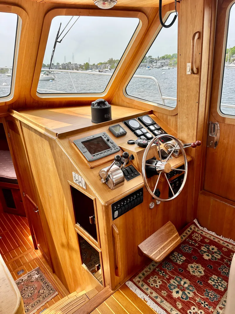 Slide: The Image of 2002 Sabreline 36 Flybridge helm with wooden interior and nautical instruments. - 14