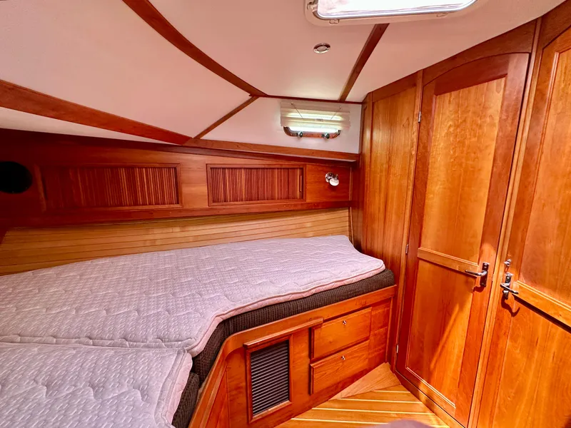 Slide: The Image of Cozy cabin interior of 2002 Sabreline 36 Flybridge with wooden finish and comfortable bedding. - 22