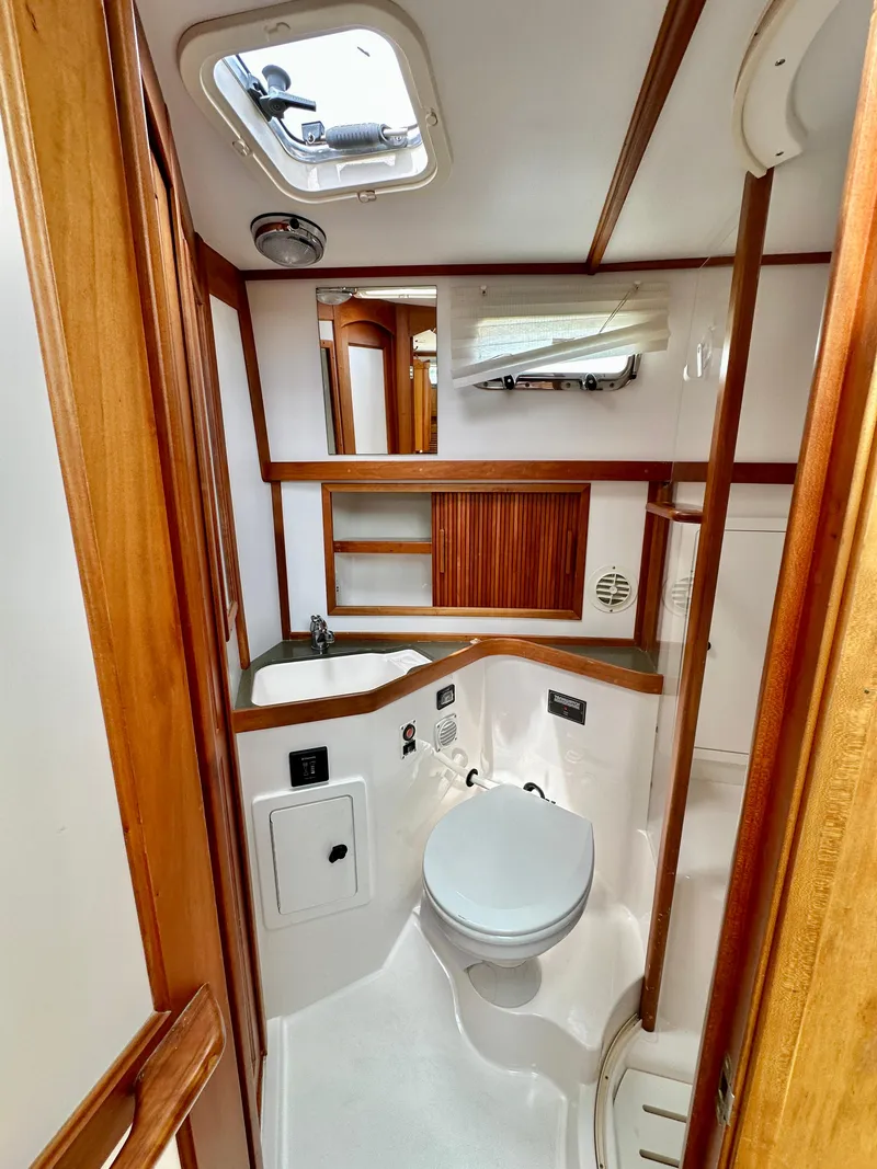 Slide: The Image of 2002 Sabreline 36 Flybridge yacht bathroom with wooden accents and compact design. - 26