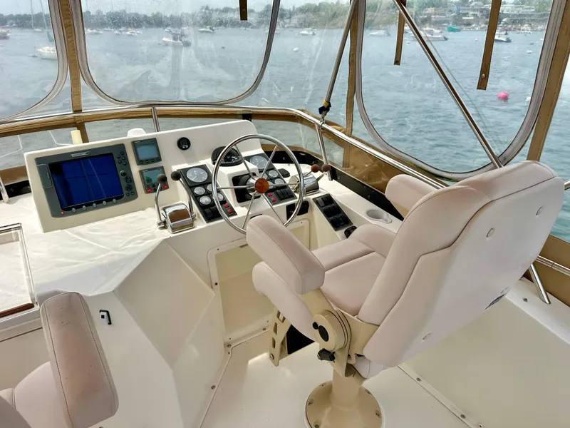 Slide: The Image of Flybridge helm of 2002 Sabreline 36, featuring steering wheel and navigation equipment. - 35