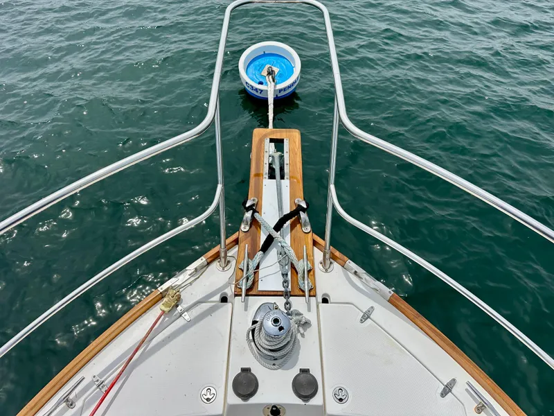 Slide: The Image of Bow view of 2002 Sabreline 36 Flybridge yacht anchored on water. - 37