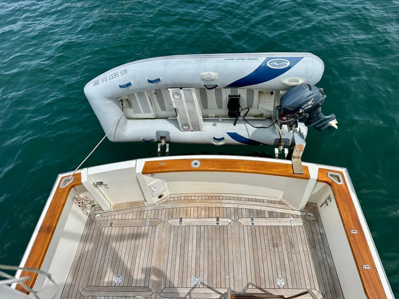 Slide: The Image of Sabreline 36 Flybridge 2002 with inflatable dinghy on calm water. - 42