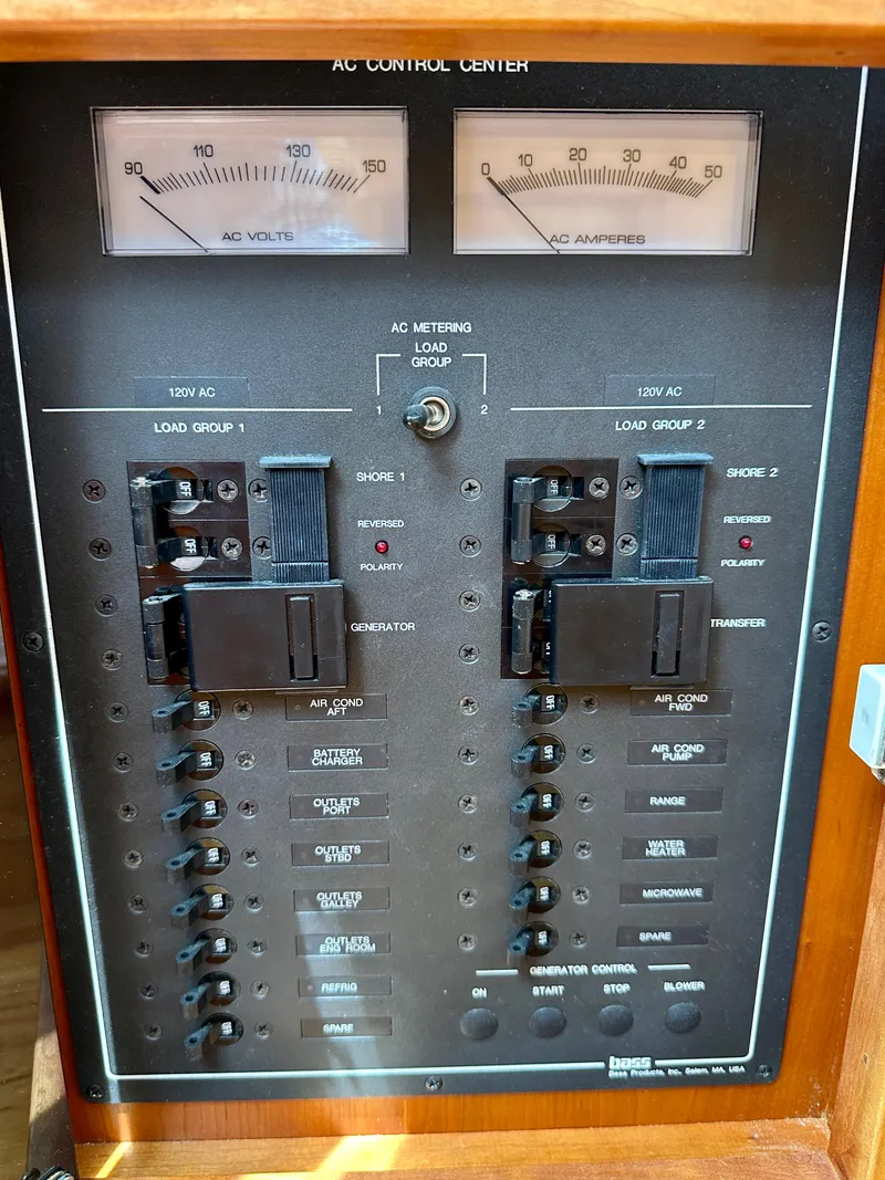 Slide: The Image of 2002 Sabreline 36 Flybridge AC control panel with volt and amp meters. - 43