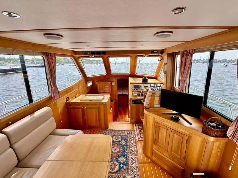 Slide: The Image of Interior of 2002 Sabreline 36 Flybridge yacht with wood finish and panoramic windows. - 11