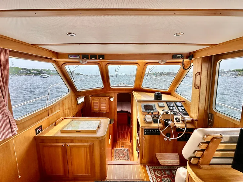 Slide: The Image of Interior view of 2002 Sabreline 36 Flybridge yacht with wooden helm and navigation area. - 12