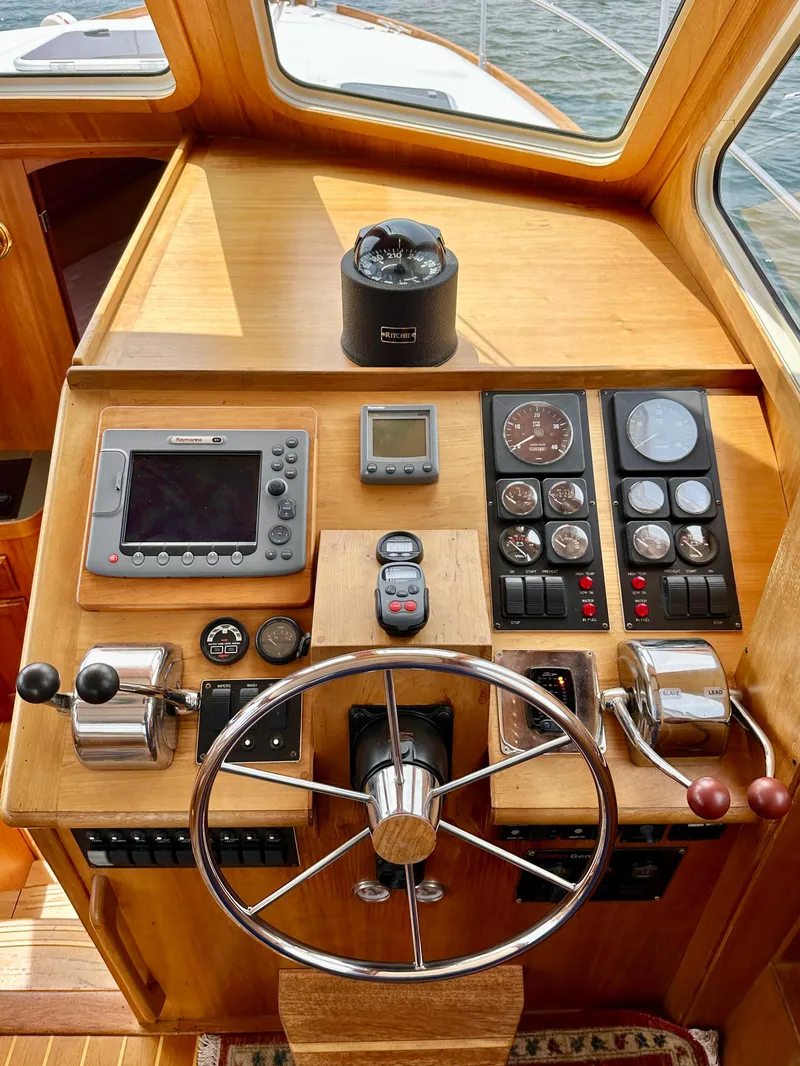 Slide: The Image of Helm of 2002 Sabreline 36 Flybridge with navigation instruments and steering wheel. - 15