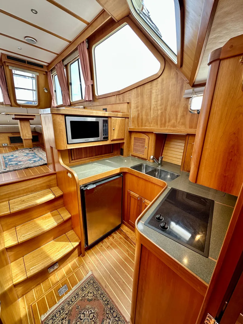 Slide: The Image of Interior of 2002 Sabreline 36 Flybridge yacht with wood finish and modern kitchen amenities. - 18