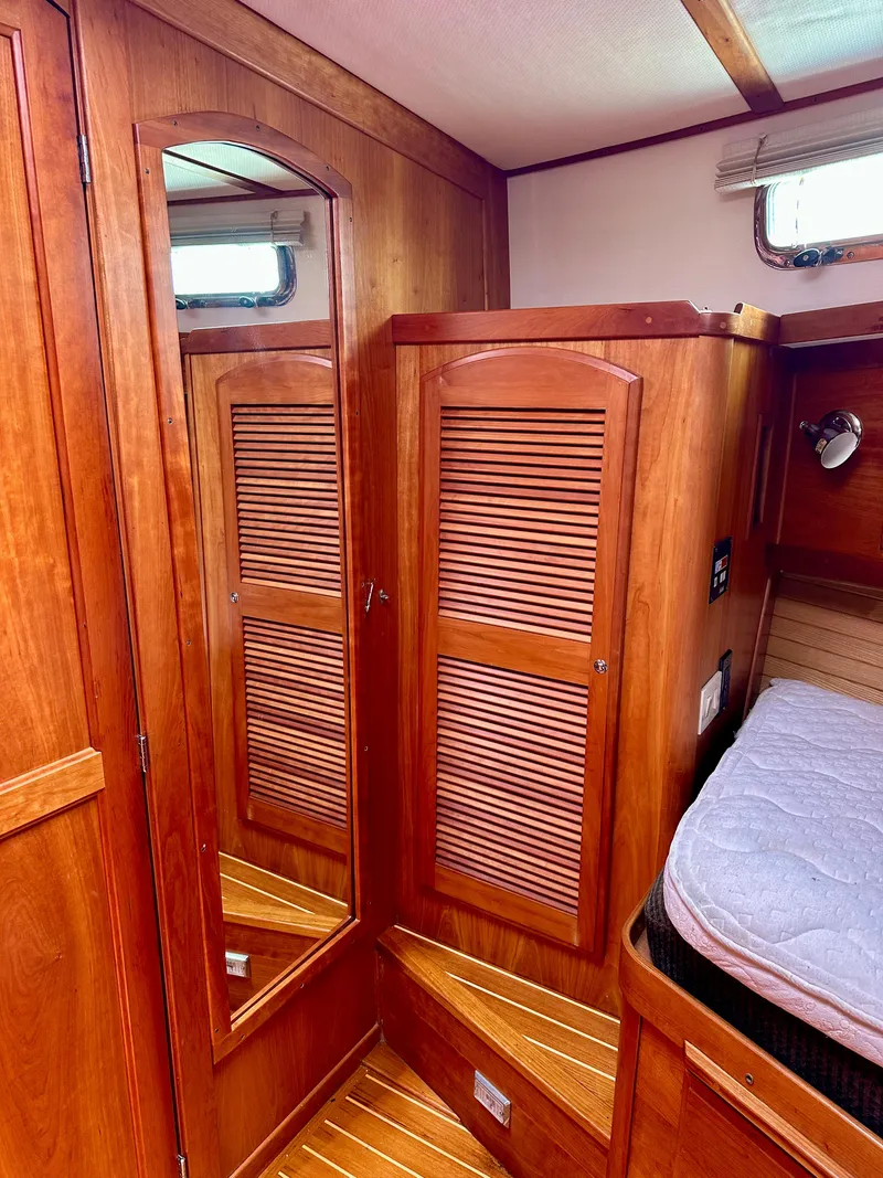 Slide: The Image of Interior of 2002 Sabreline 36 Flybridge with wooden cabinetry and mirror. - 20