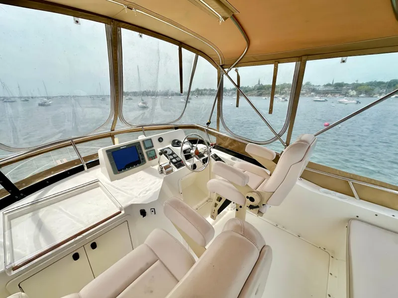 Slide: The Image of Flybridge of 2002 Sabreline 36, featuring helm station with dual seats and panoramic view. - 30