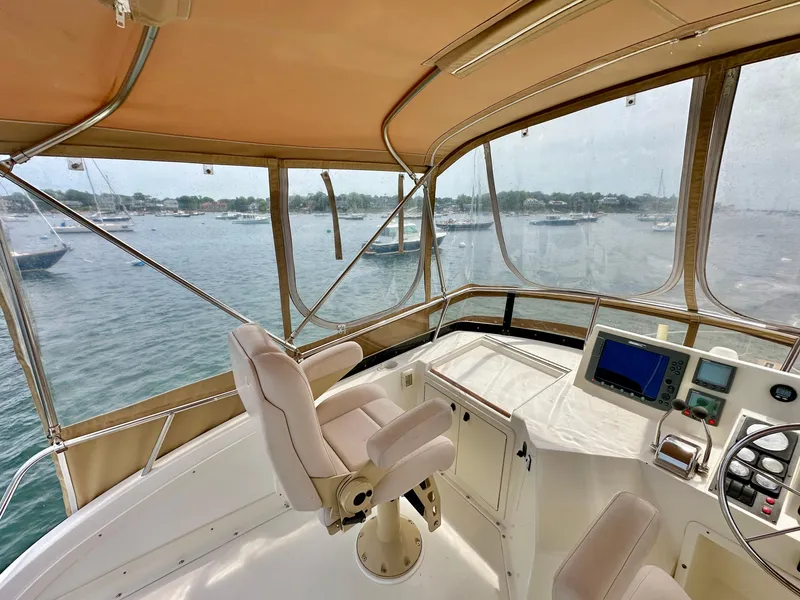 Slide: The Image of 2002 Sabreline 36 Flybridge interior with helm, overlooking marina. - 31