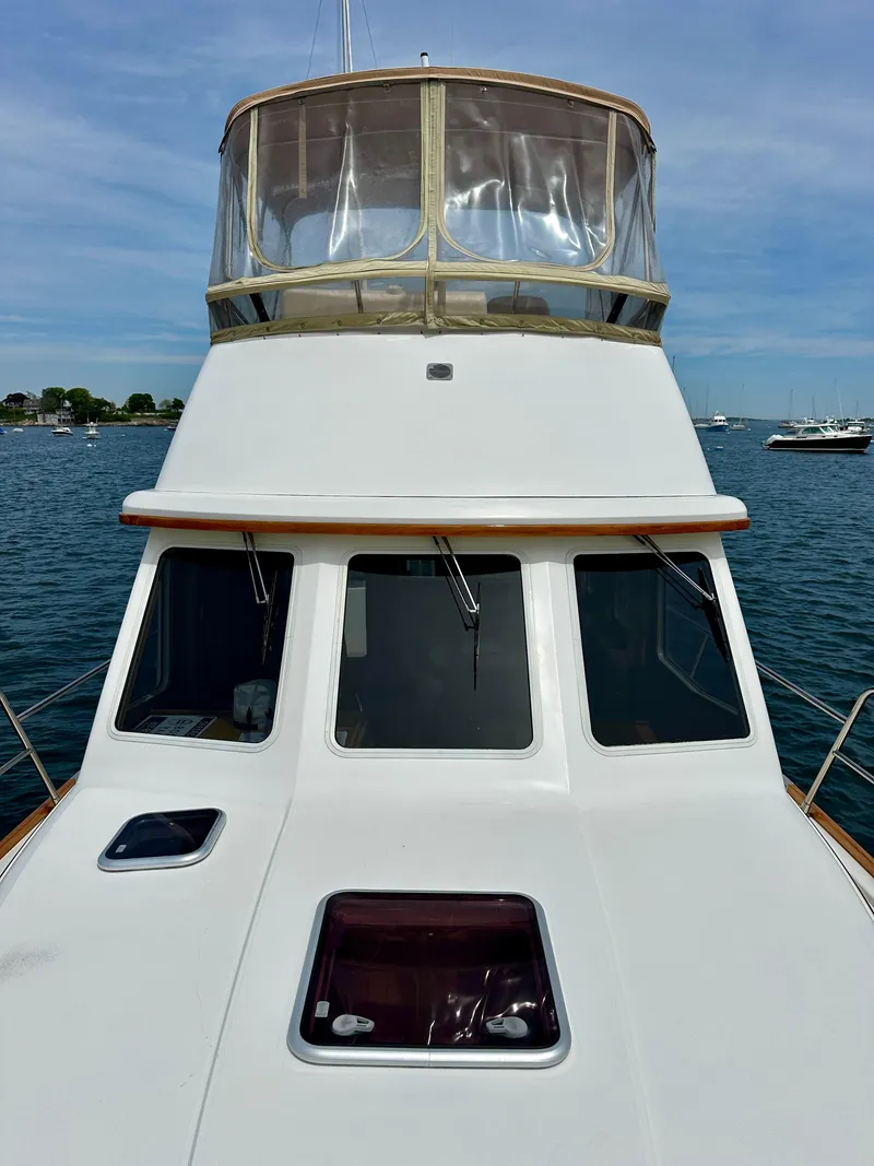 Slide: The Image of 2002 Sabreline 36 Flybridge boat on water, showcasing flybridge and windows. - 36