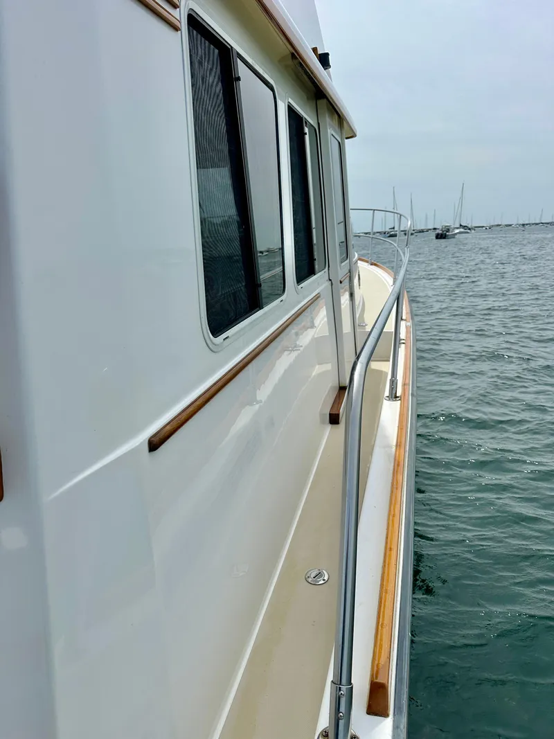 Slide: The Image of Side view of 2002 Sabreline 36 Flybridge yacht on water. - 39