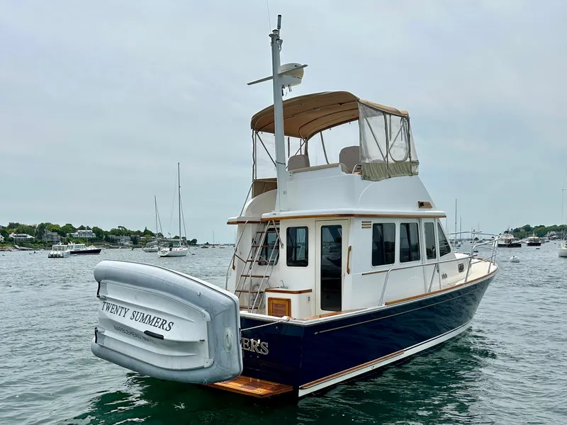 Slide: The Image of 2002 Sabreline 36 Flybridge yacht on water, featuring a blue hull and flybridge canopy. - 4
