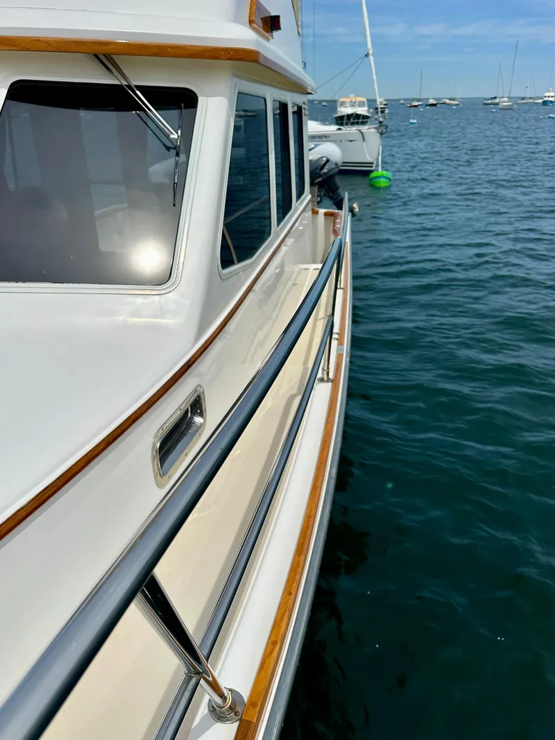Slide: The Image of 2002 Sabreline 36 Flybridge yacht on calm water, showcasing sleek design and craftsmanship. - 40