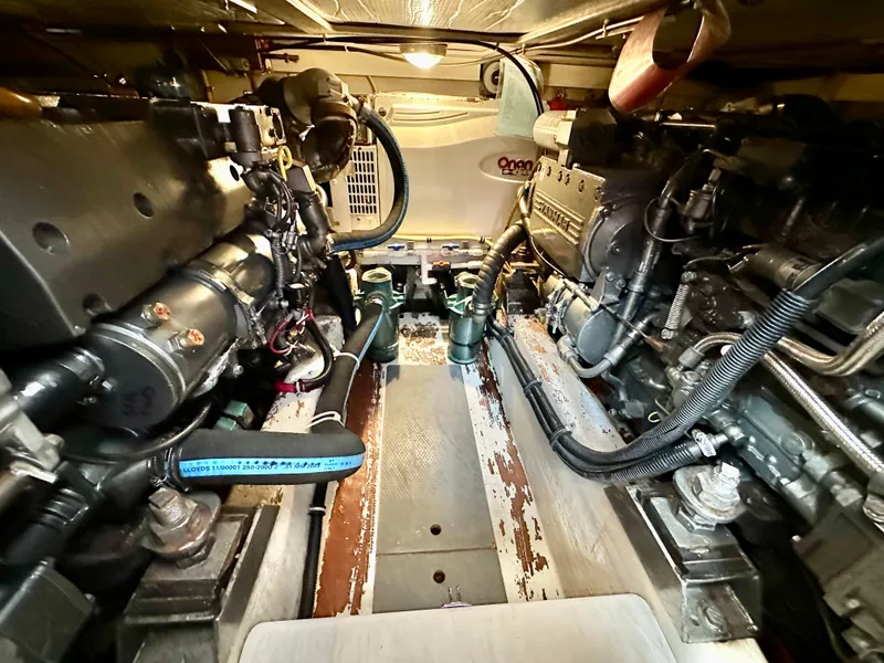 Slide: The Image of Engine room of 2002 Sabreline 36 Flybridge, showcasing dual engines and mechanical components. - 46