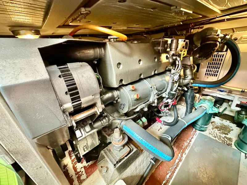 Slide: The Image of Engine compartment of a 2002 Sabreline 36 Flybridge boat, showcasing mechanical components. - 47