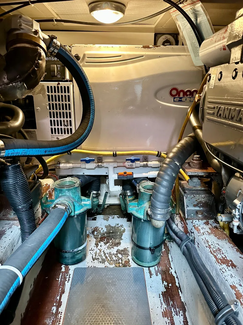 Slide: The Image of Engine room of 2002 Sabreline 36 Flybridge with Onan generator and Yanmar engine components. - 49