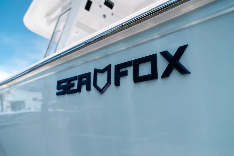 Slide: The Image of 2025 Sea Fox 228 Commander boat logo on sleek white hull. - 10