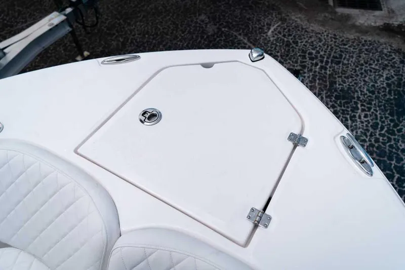 Slide: The Image of 2025 Sea Fox 228 Commander boat deck with storage compartment and seating. - 12