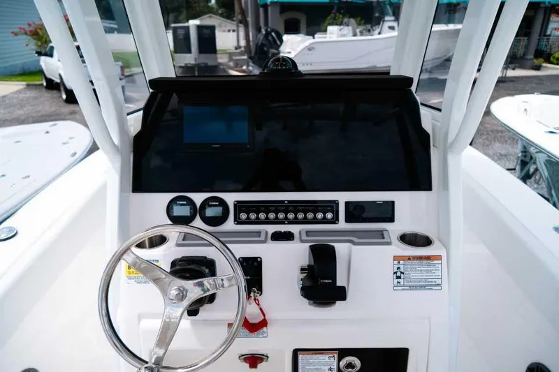 Slide: The Image of 2025 Sea Fox 228 Commander boat dashboard with steering wheel and control panel. - 19