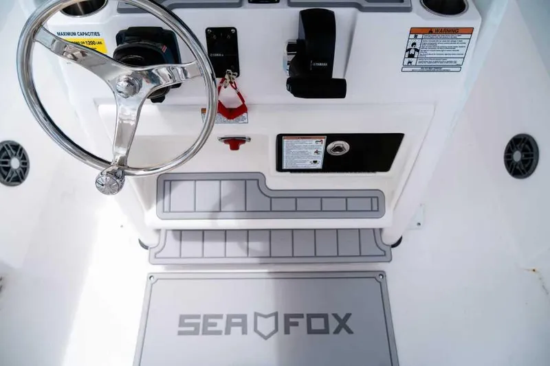 Slide: The Image of 2025 Sea Fox 228 Commander helm with steering wheel and controls. - 20