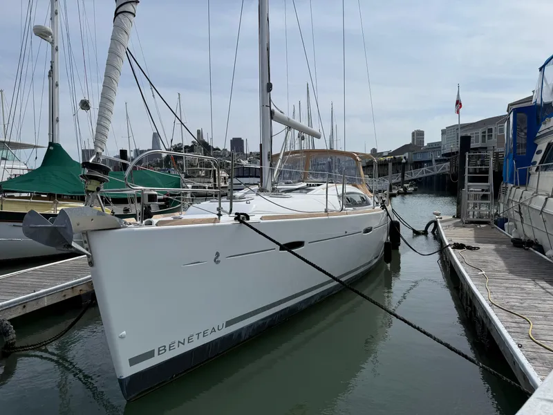 Slide: The Image of 2008 Beneteau Oceanis 40 sailboat docked at a marina, surrounded by other boats. - 1