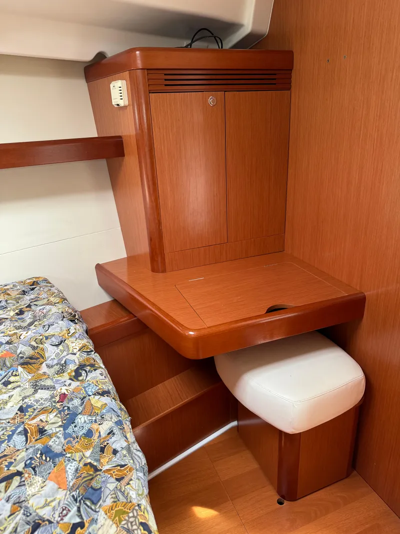 Slide: The Image of Cozy cabin interior of 2008 Beneteau Oceanis 40 with wooden desk and patterned bedding. - 10