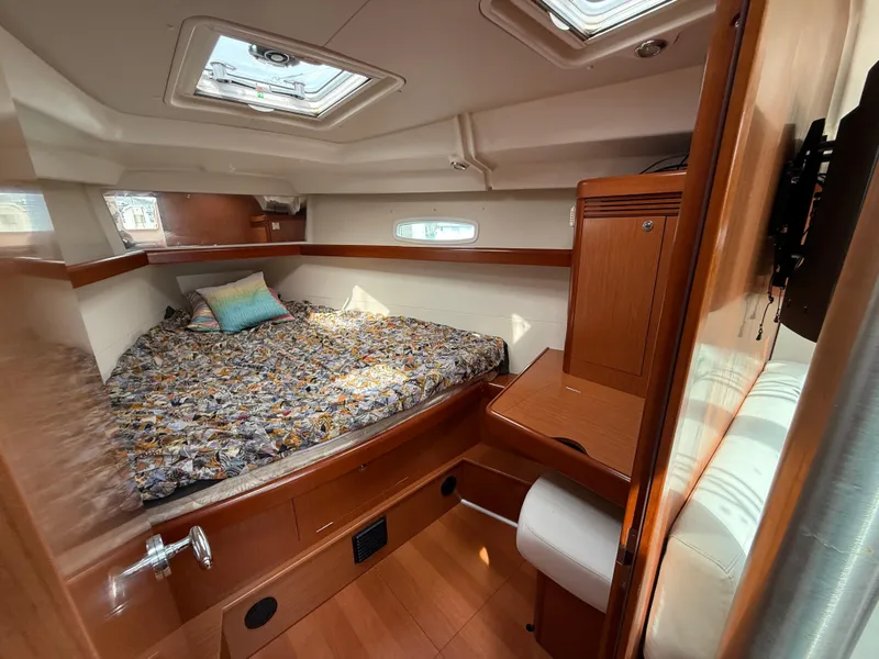Slide: The Image of Cozy cabin interior of 2008 Beneteau Oceanis 40 sailboat with bed and wooden furnishings. - 11