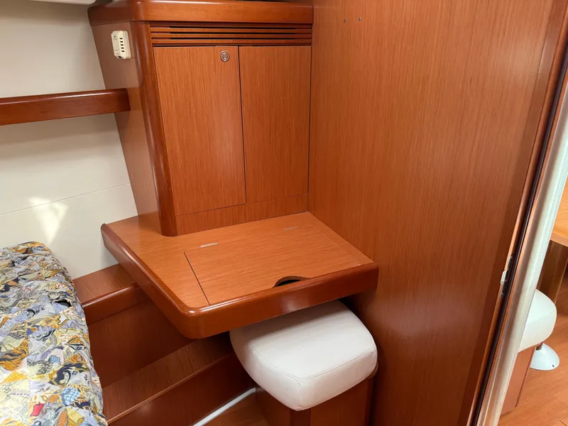 Slide: The Image of Interior of 2008 Beneteau Oceanis 40 yacht with wooden cabinetry and cushioned seating. - 14