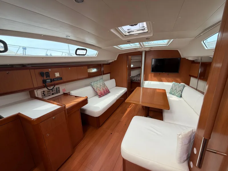 Slide: The Image of Interior of 2008 Beneteau Oceanis 40 yacht with wood finish and white seating. - 16