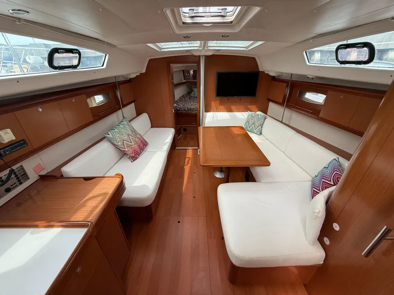 Slide: The Image of Interior of 2008 Beneteau Oceanis 40 yacht with wood finish and white seating. - 17