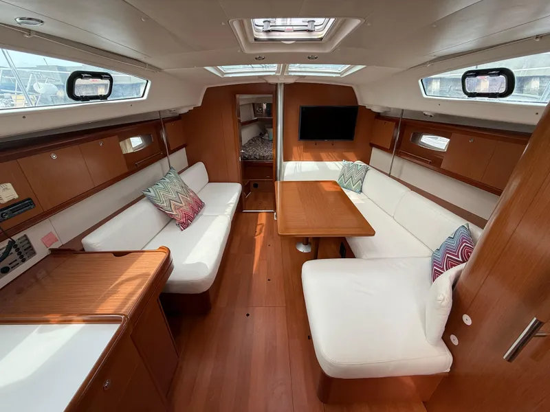 Slide: The Image of Interior of 2008 Beneteau Oceanis 40 yacht with wood finish and white seating. - 18