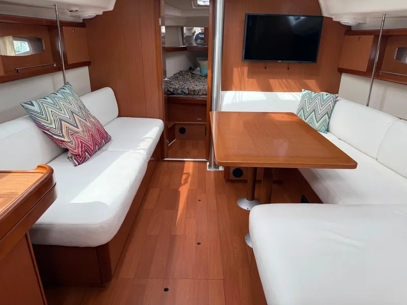 Slide: The Image of Interior of 2008 Beneteau Oceanis 40 yacht with cozy seating and wooden table. - 19