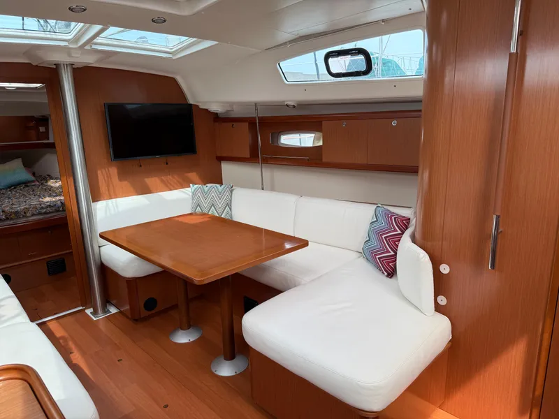 Slide: The Image of Interior of 2008 Beneteau Oceanis 40 yacht with cozy seating and wooden finishes. - 20