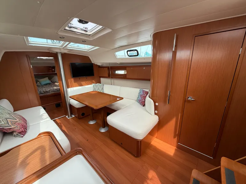 Slide: The Image of Interior of 2008 Beneteau Oceanis 40 yacht with wood finish and white seating. - 21