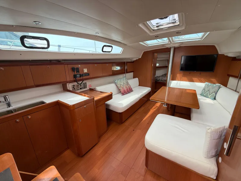 Slide: The Image of Interior of 2008 Beneteau Oceanis 40 yacht with wood finish and white seating. - 22