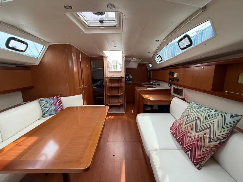 Slide: The Image of Interior of 2008 Beneteau Oceanis 40 sailboat with wood finish and colorful cushions. - 25