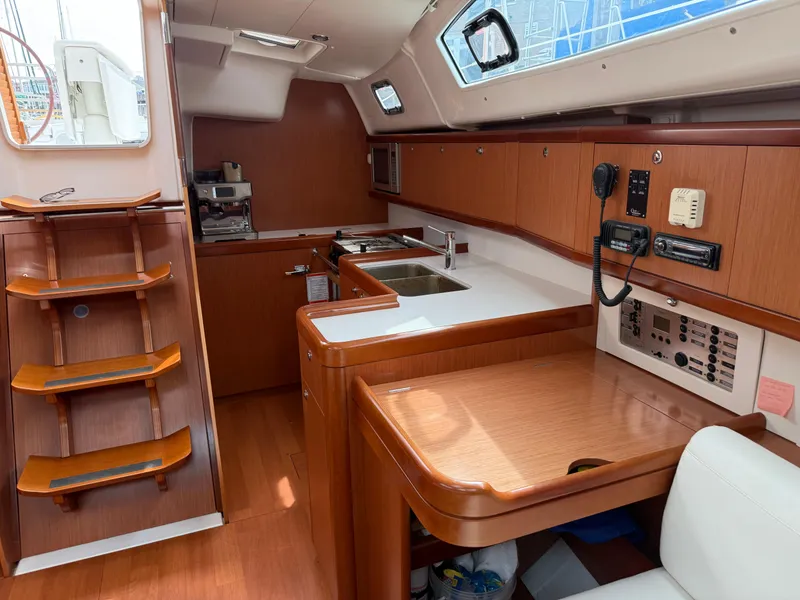 Slide: The Image of Interior of 2008 Beneteau Oceanis 40 yacht, featuring a modern kitchen and navigation area. - 28