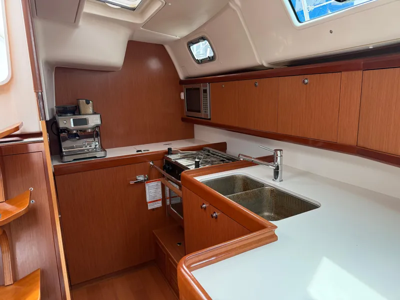 Slide: The Image of Galley kitchen in 2008 Beneteau Oceanis 40 yacht with wood cabinetry and modern appliances. - 31